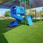 SYNLawn Playground turf with blue jungle gym
