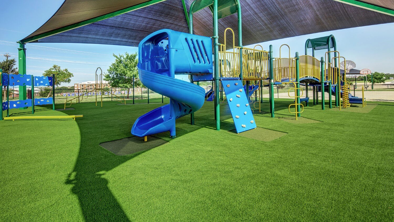 SYNLawn Playground turf with blue jungle gym