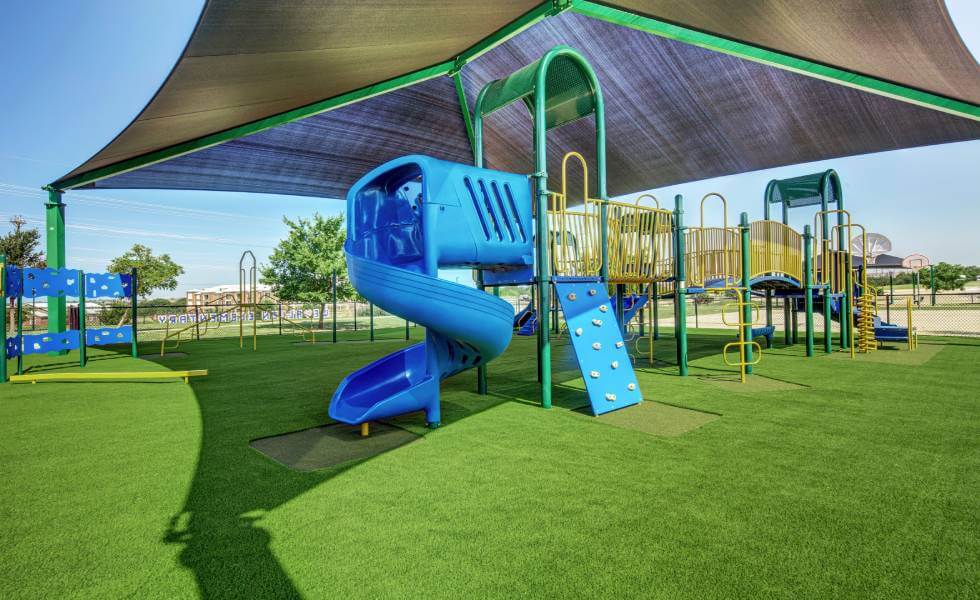 Blue Jungle Gym installed on SYNLawn playground turf for frisco independent school district