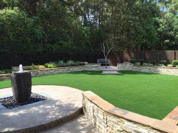 Bench and fountain area with artificial grass