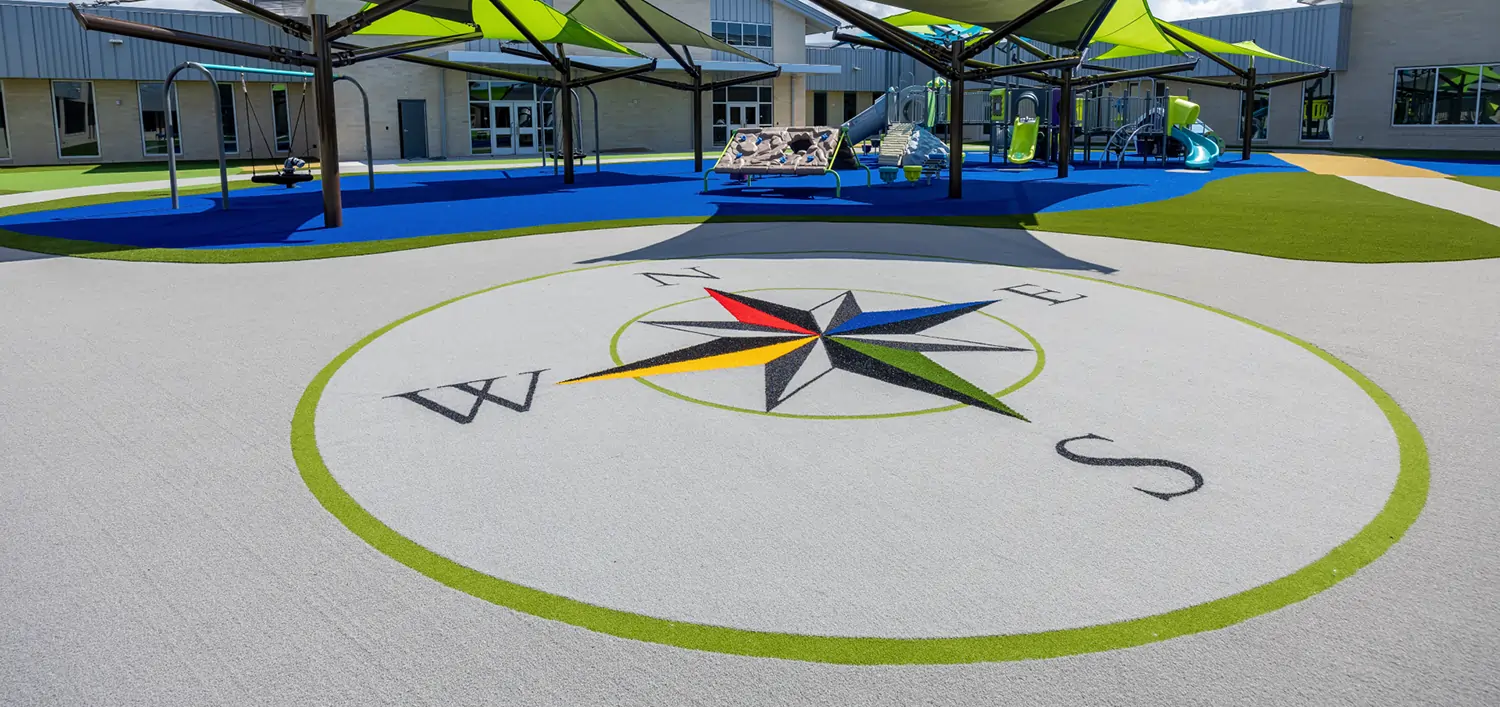 Artificial grass compass playground installed by SYNLawn