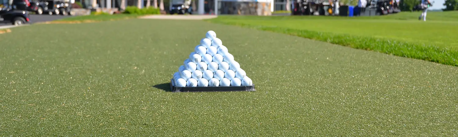 Golf balls stacked on SYNLawn artificial grass tee line