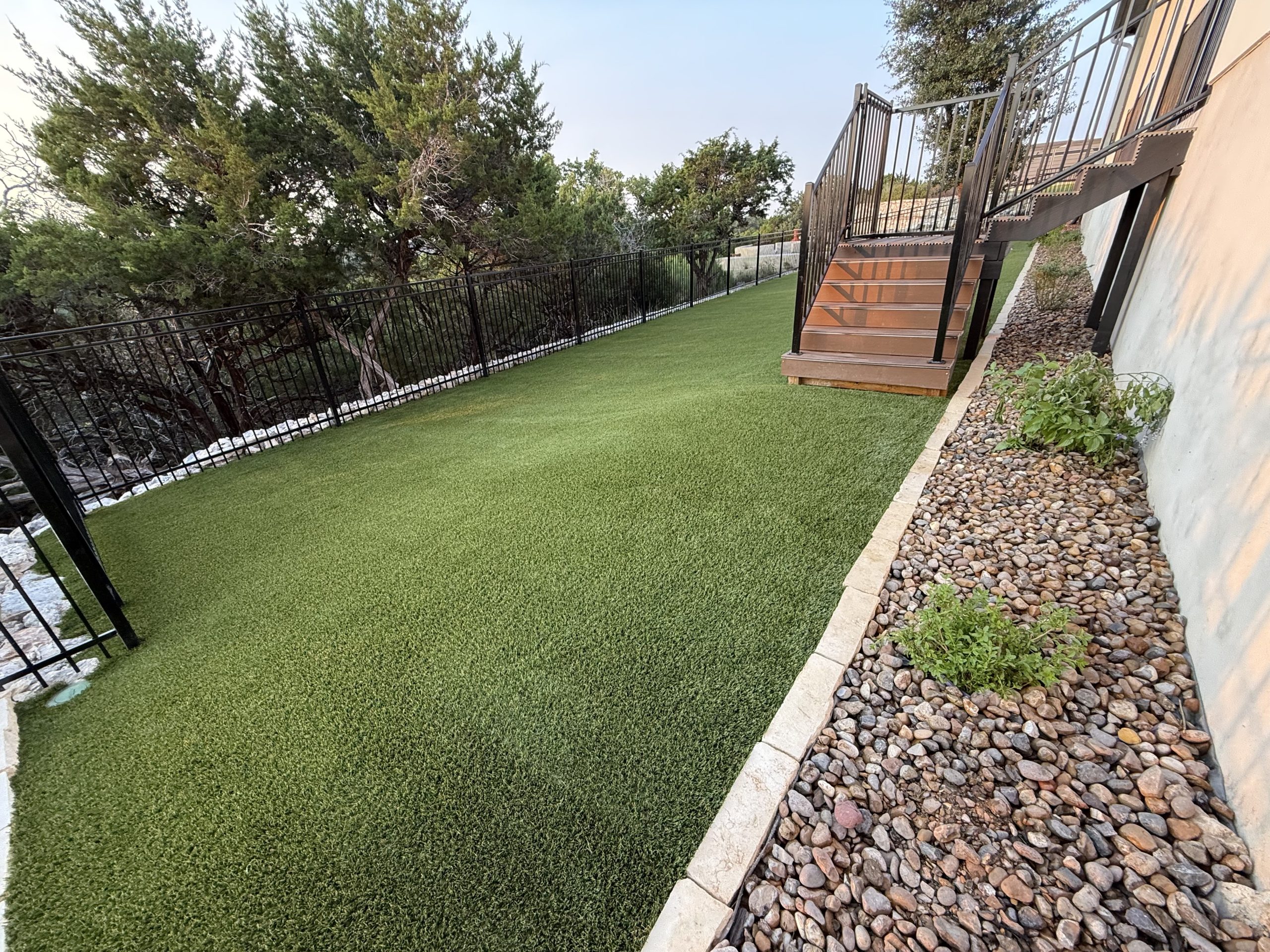 San Antonio Artificial Grass Side Yard with Deck Stairs and Landscape Rock Border San Antonio Artificial Grass Side Yard with Deck Stairs and Landscape Rock Border